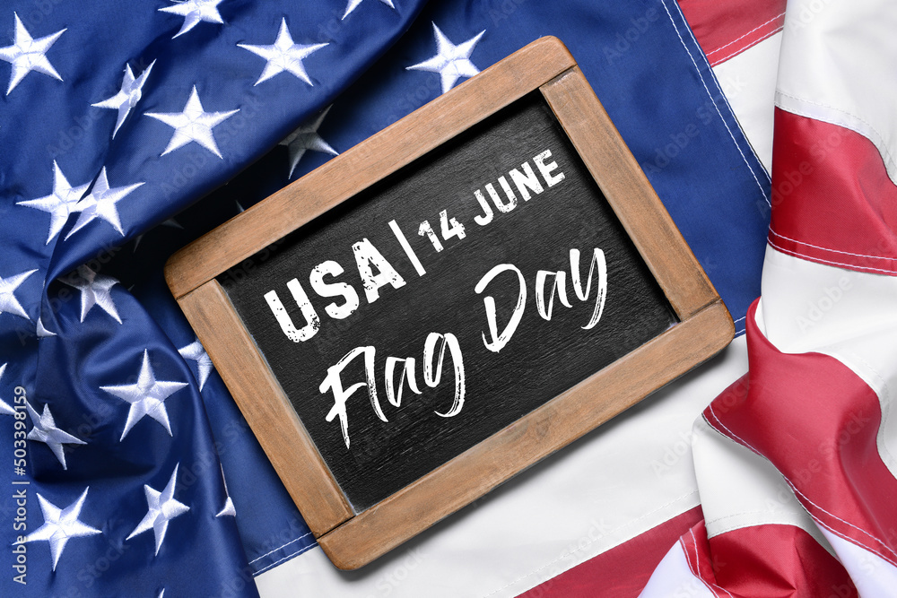 Fototapeta premium Chalkboard with text 14 JUNE, FLAG DAY on American flag, top view