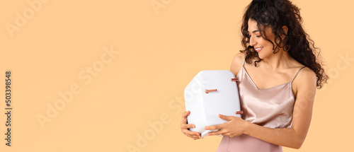 Happy young woman holding c...