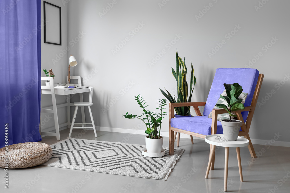 Stylish interior with armchair, table and houseplants - obrazy, fototapety, plakaty 