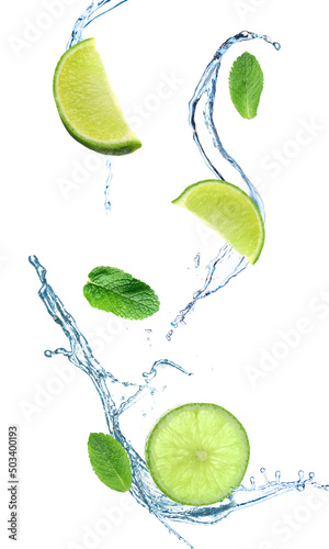 Cut lime, mint leaves and splash of water isolated on white