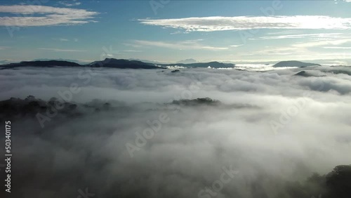 Mountain peaks  emerge out of dense advection fog settling into tropical forest, Costa Rica, aerial photo