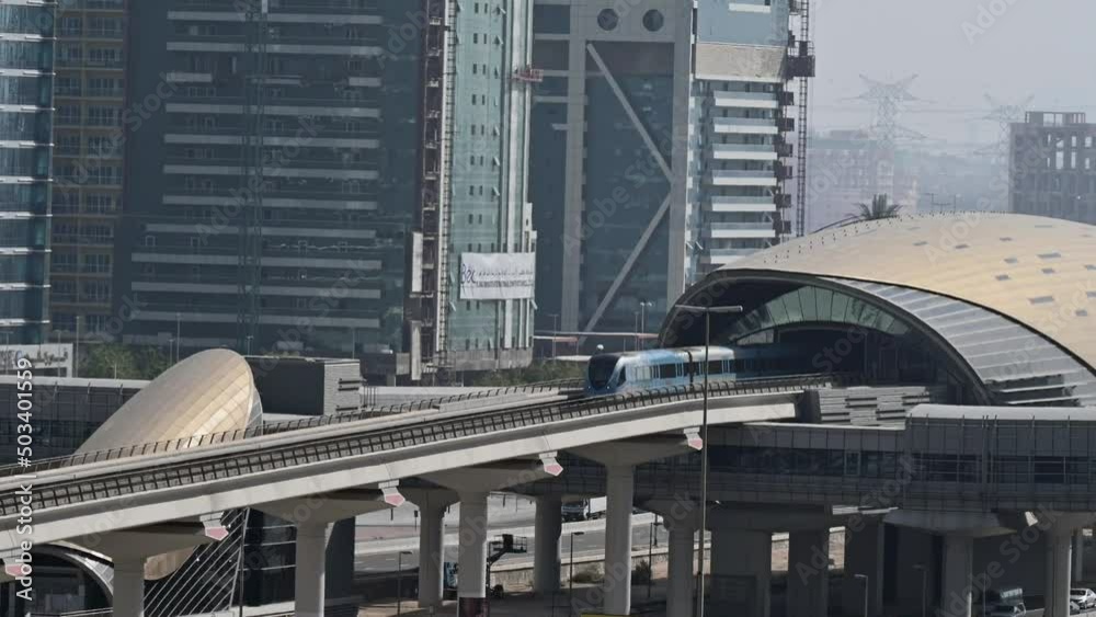 4K: Dubai Metro train leaving the station. The Metro is a rapid transit rail network in Dubai, United Arab Emirates. 4K: Dubai Metro train leaving the station. The Metro is a rapid transit rail network in Dubai, United Arab Emirates.