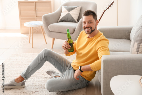 Handsome man drinking beer ...