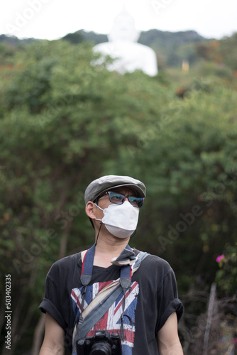 portrait person one, wearing a hygienic mask and carrying a camera. Travel chilling on holidays. Concept, New Normal and social distance.