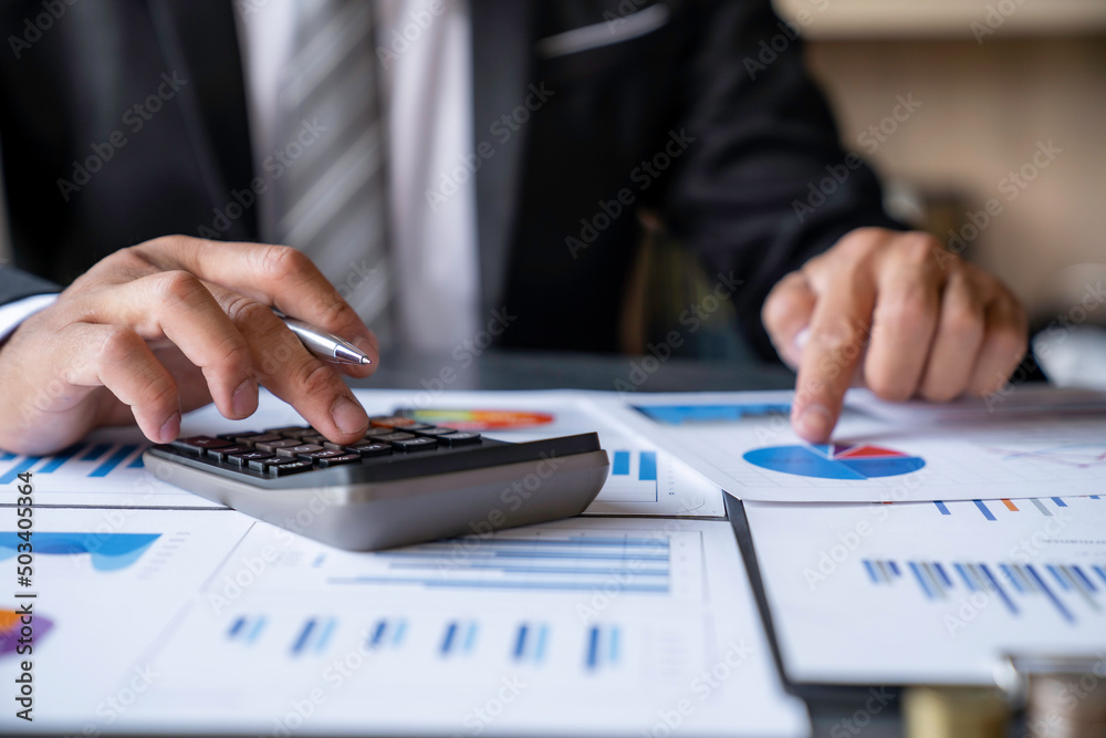 Businessman accountant using calculator and laptop for calculating finance on desk office. business financial accounting concept. Businessman accountant using calculator and laptop for calculating finance on desk office. business financial accounting concept.