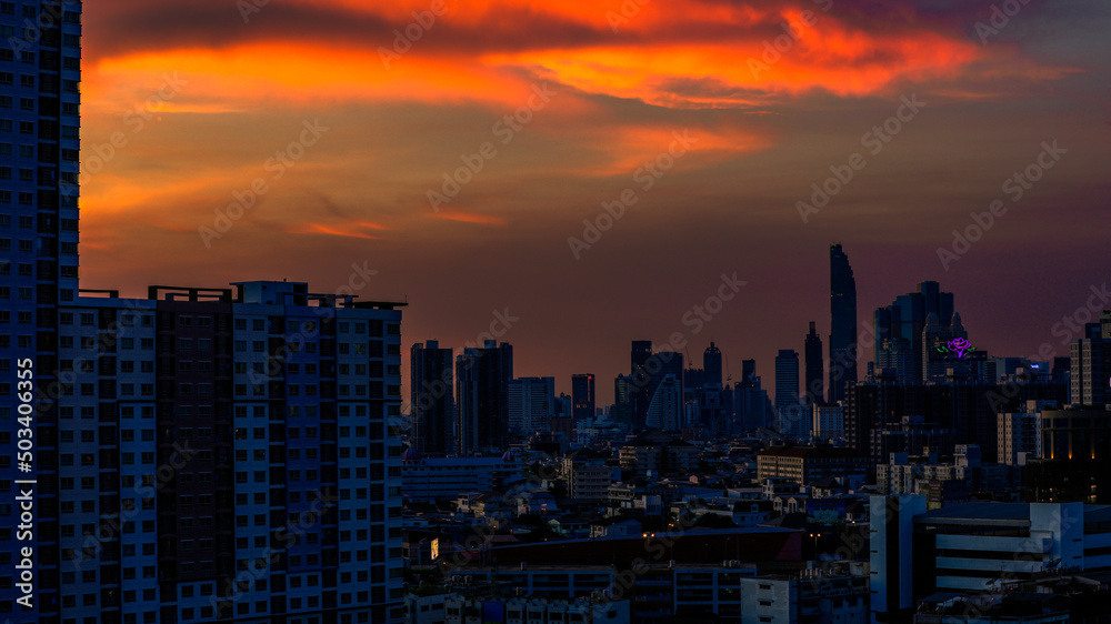 The high angle background of the city view with the secret light of the evening, blurring of night lights, showing the distribution of condominiums, dense homes in the capital community