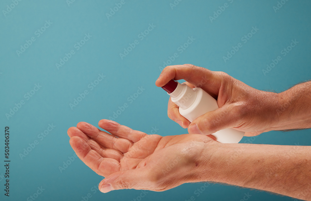 Crop man disinfecting hands with sanitizer Crop man disinfecting hands with sanitizer