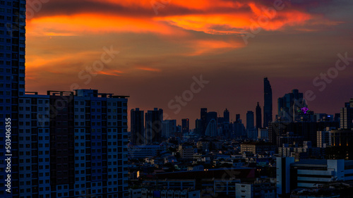 The high angle background of the city view with the secret light of the evening, blurring of night lights, showing the distribution of condominiums, dense homes in the capital community