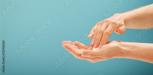 Anonymous woman taking cream from hand