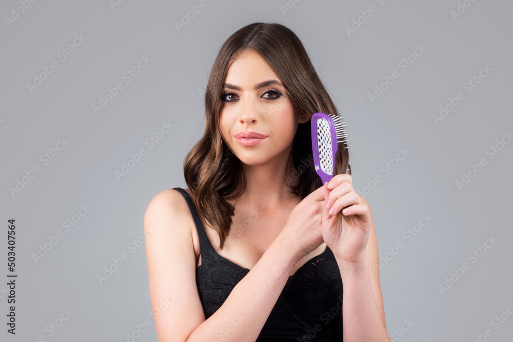 Close up portrait of happy beautiful girl with shiny hair with comb. Attractive smiling woman brushing hair. Close up portrait of happy beautiful girl with shiny hair with comb. Attractive smiling woman brushing hair.