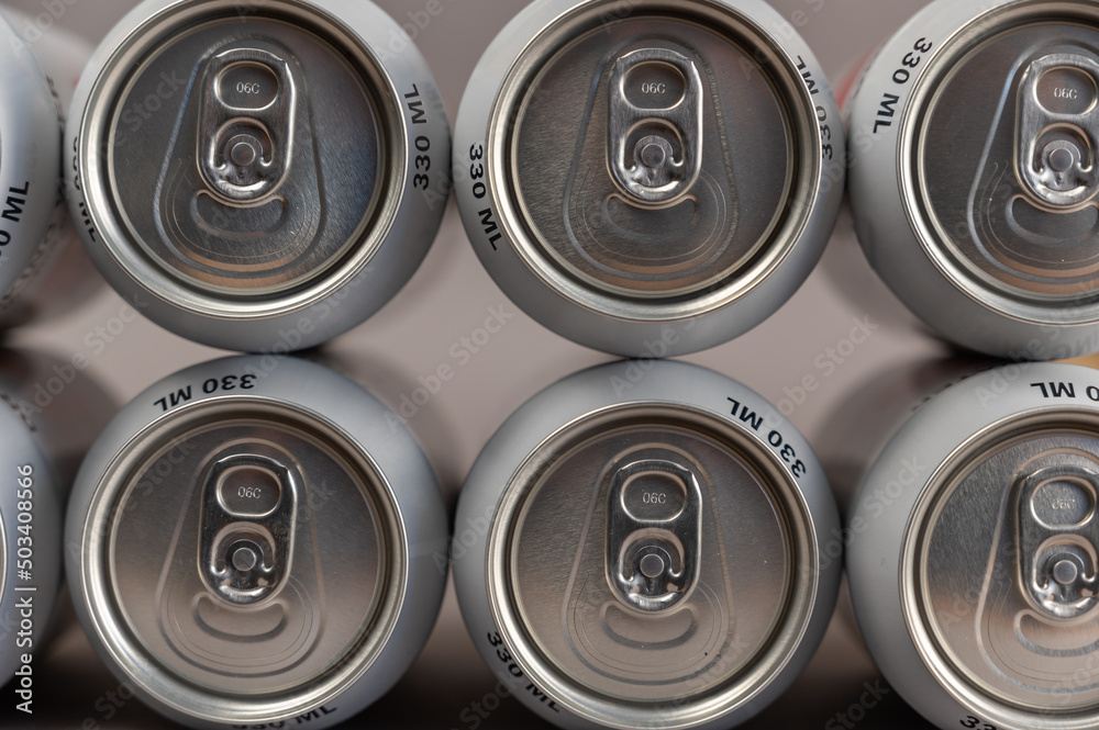 Geometric composition of full tin cans. Cylindrical silver individual beverage containers. Close-up. Selective focus. Geometric composition of full tin cans. Cylindrical silver individual beverage containers. Close-up. Selective focus.