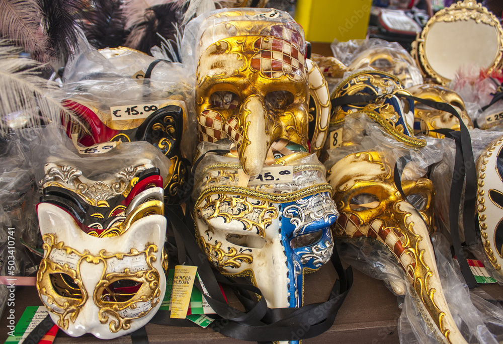 Venetian masks on shelves of outdoor market in Verona, Italy
