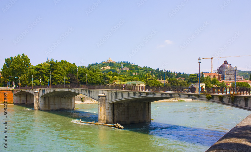Cituscape with bridge across Adige river in Verona, Italy