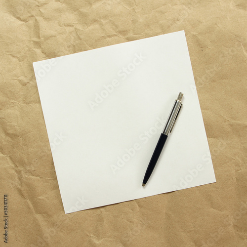Wallpaper Mural Square white empty sheet of paper with pen on a beige craft paper. Concept of analysis, study, attentive work. Stock photo with empty place for your text and design. Square image shape. Torontodigital.ca