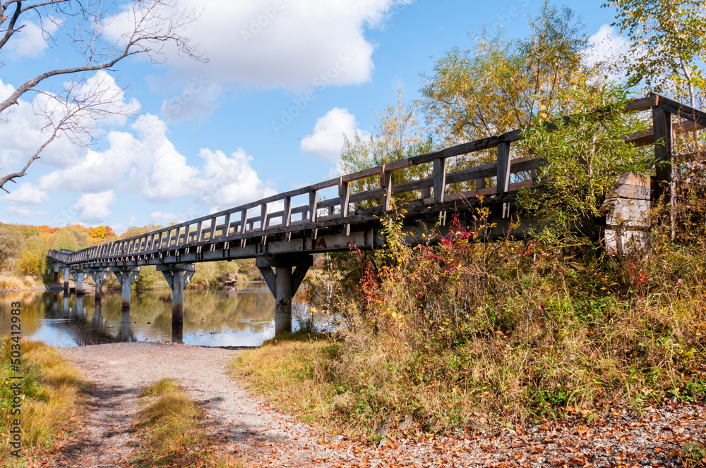 Autumn landscape: wooden bridge over the Kiya River near the village of Pereyaslavka, Khabarovsk Territory of Russia Autumn landscape: wooden bridge over the Kiya River near the village of Pereyaslavka, Khabarovsk Territory of Russia