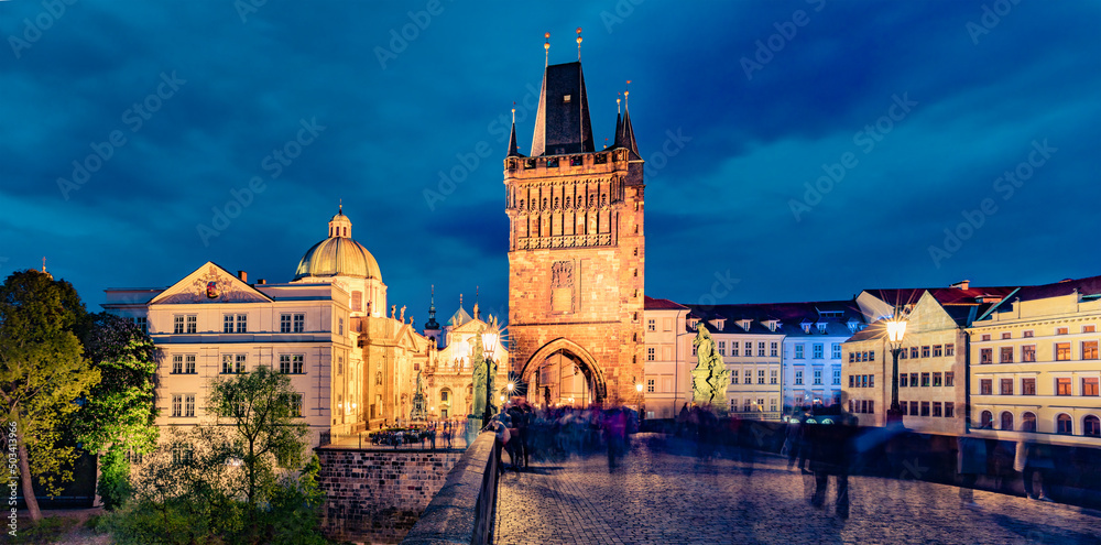 Amazing night view of Charles bridge on Vltava river (Karluv Most) with statues and Prague castle. Illuminated evening cityscape in Prague, Czech Republic, Europe. Architecture traveling background..