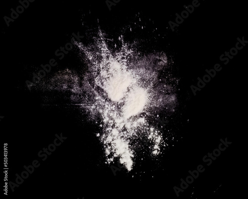 White powder explosion isolated on Dark background. White dust particles splash. Powder Explosion dust explodes Holy Festival.