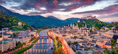 Panoramic summer cityscape of Salzburg, Old City, birthplace of famed composer Mozart. Great sunset in Eastern Alps, Austria, Europe. Adorable evening landscape with Salzach river.