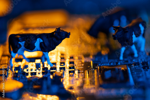 Mother board and cow figurines symbolizing agricultural digitization photo