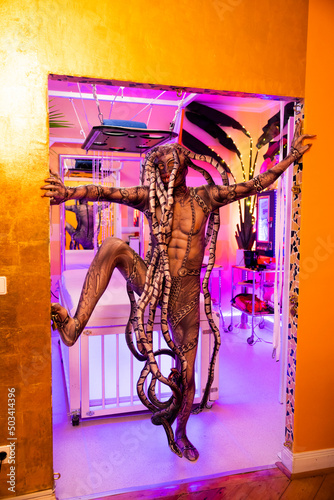Man wearing spooky Medusa costume standing in doorway of SM studio photo