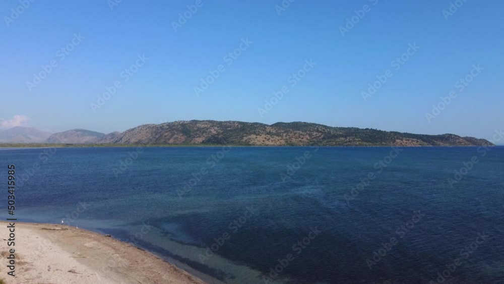 Drone shot of the Albanian coast in the Mediterranean sea - drone is ascending from the beach. Snippet could ideally be used for travel related videos or nature movies. Drone shot of the Albanian coast in the Mediterranean sea - drone is ascending from the beach. Snippet could ideally be used for travel related videos or nature movies.
