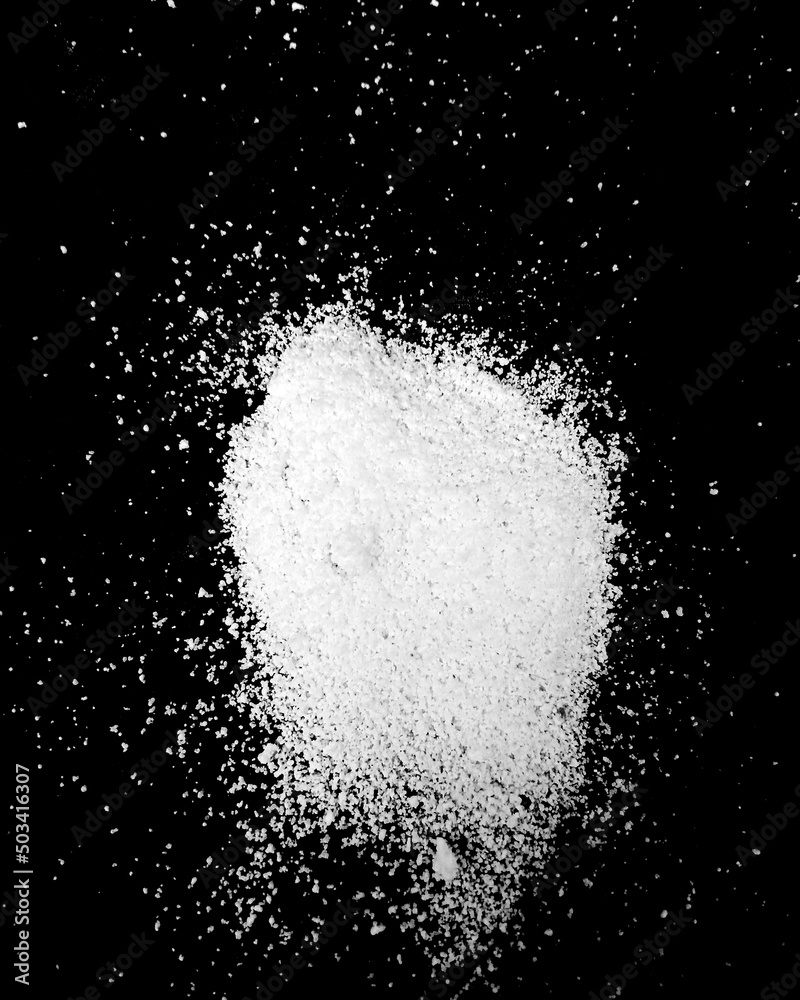 White powder explosion isolated on Dark background. White dust particles splash. Powder Explosion dust explodes Holy Festival.