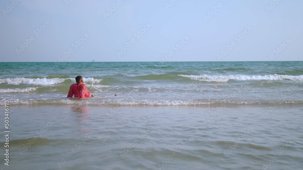 African businessman relaxing on the beach during the weekend. African businessman relaxing on the beach during the weekend.