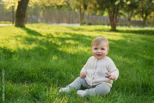 Smiling baby boy on grass in park. Children Protection Day. World Children's Day