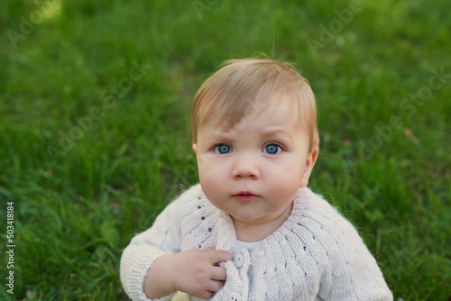 Smiling baby boy on grass in park. Children Protection Day. World Children's Day