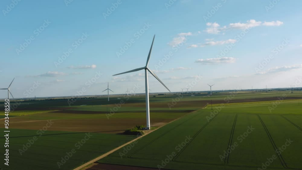 Solar power plant and Windmills aerial view. Renewable energy. Green tech. Farm windmills at sunset. Wind turbines power farm Future technology. Wind power turbines generating. Aerial. Drone. 4K. Solar power plant and Windmills aerial view. Renewable energy. Green tech. Farm windmills at sunset. Wind turbines power farm Future technology. Wind power turbines generating. Aerial. Drone. 4K.
