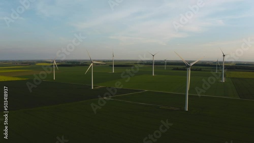 Solar power plant and Windmills aerial view. Renewable energy. Green tech. Farm windmills at sunset. Wind turbines power farm Future technology. Wind power turbines generating. Aerial. Drone. 4K.  photo