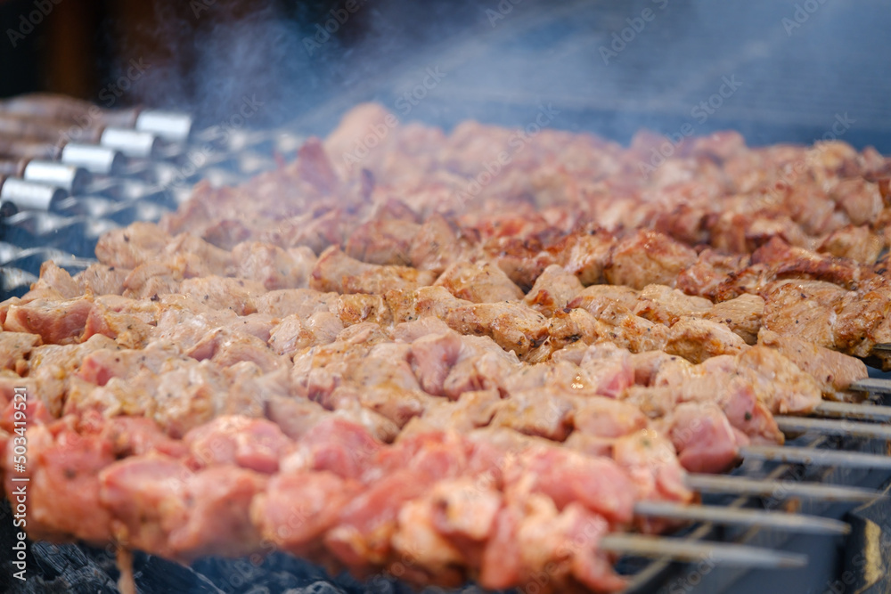 Pork skewers frying on brazier Pork skewers frying on brazier