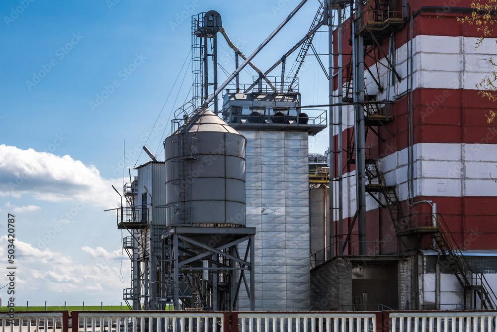 agro silos granary elevator on agro-processing manufacturing plant for processing drying cleaning and storage of agricultural products, flour, cereals and grain.