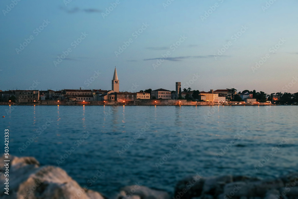 Porec city sideview with sunset.