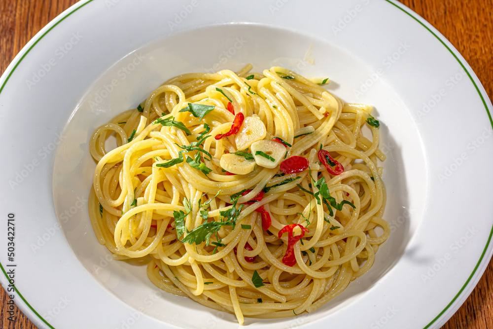 Vegetarian Italian Pasta Spaghetti Aglio E Olio with garlic bread, red chili flake, parsley, parmesan cheese. Vegetarian Italian Pasta Spaghetti Aglio E Olio with garlic bread, red chili flake, parsley, parmesan cheese.