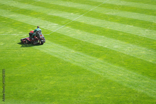 Mowing grass ion the pitch of the football stadium