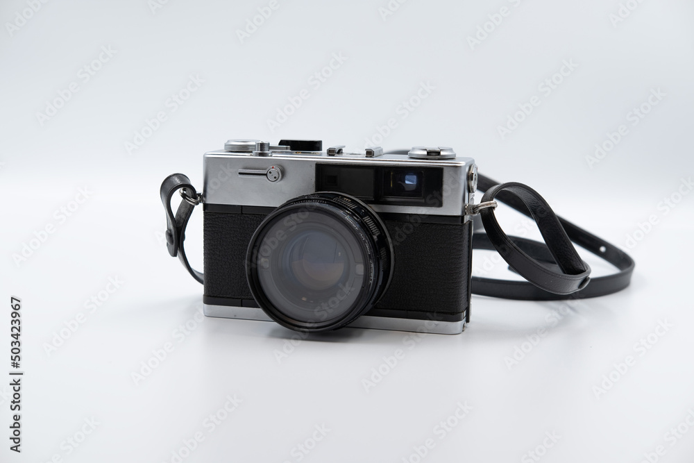 Isolated white background Beautiful vintage analog rangefinder film camera. 70's Decade film camera. Front view image.