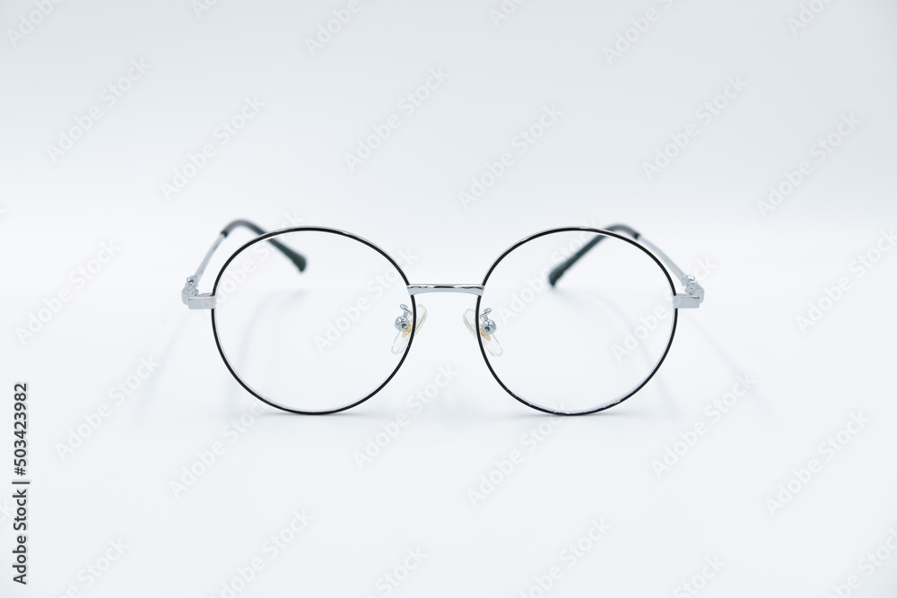 Isolated white background, Selective focus round eyeglasses with silver rim. Isolated white background, Selective focus round eyeglasses with silver rim.