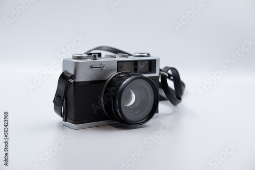 Isolated white background Beautiful vintage analog rangefinder film camera. 70's Decade film camera. Front right view image.