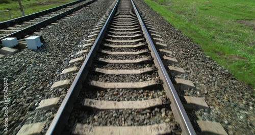 Railway track view in motion. Rails for trains. Railway track in the direction of travel first-person view. photo