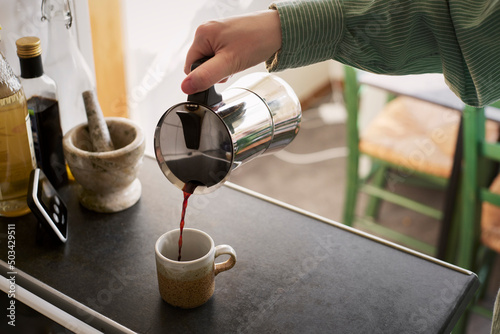 Woman pouring coffee into cup