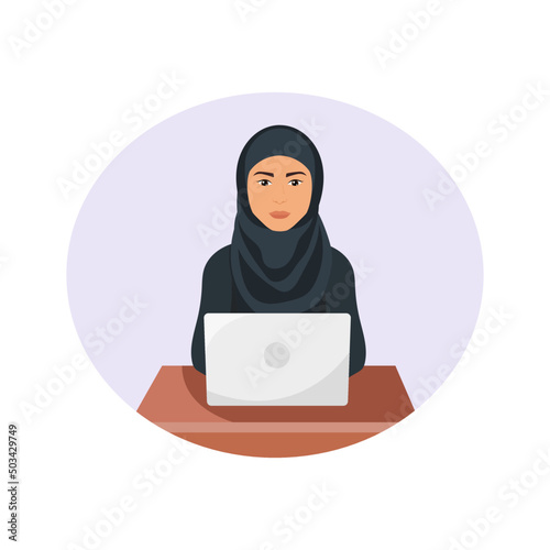 Woman wearing traditional muslim clothes work on computer