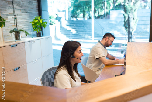 Two receptionists working at the front desk of a physiotherapy health center.