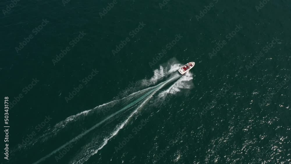 white boat moving fast diagonally video Drone. Fast boat movements with people aerial view.