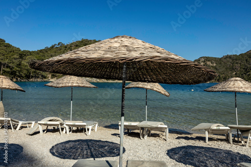 Beach umbrellas in Oludeniz at sunny day  Turkey.