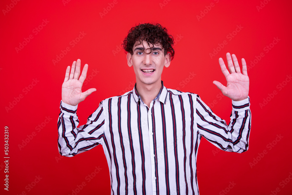 Naklejka premium Emotions of a young attractive guy. Orange background.