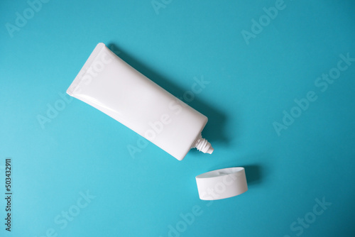 Wallpaper Mural A blank white squeeze bottle plastic tube on blue background. Packaging of cream, lotion, gel, facial foam or skincare. Cosmetic beauty product branding mock-up. Copy space Torontodigital.ca