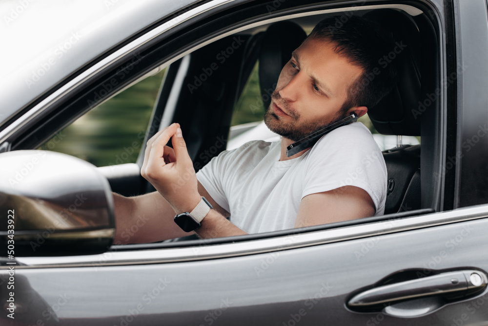 Man talking on the phone while driving a car