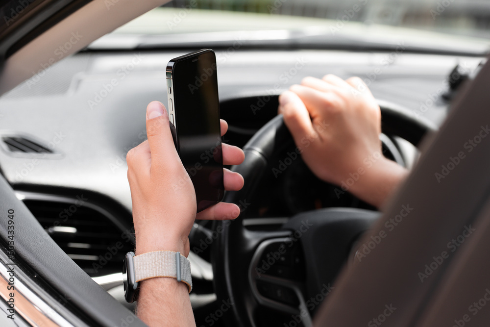 Man using phone in car