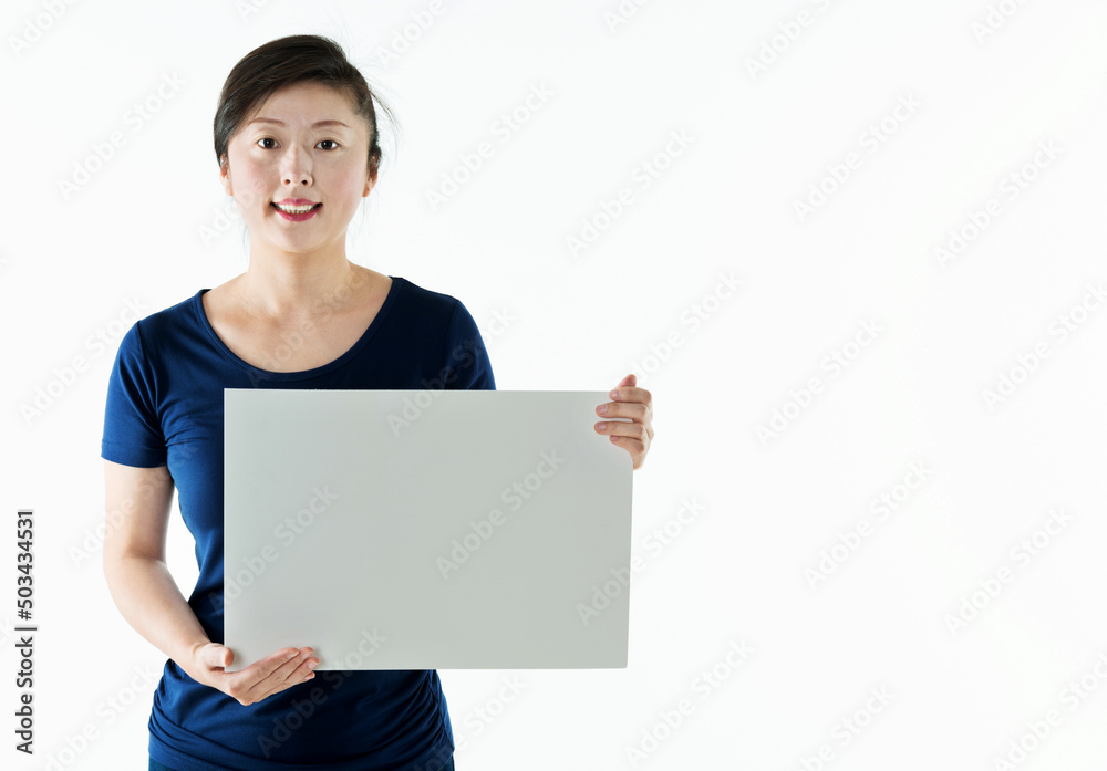 Beautiful asian woman holding a blank board isolated on white background Beautiful asian woman holding a blank board isolated on white background